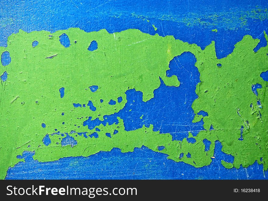 Remnants of green  paint on blue plastic surface