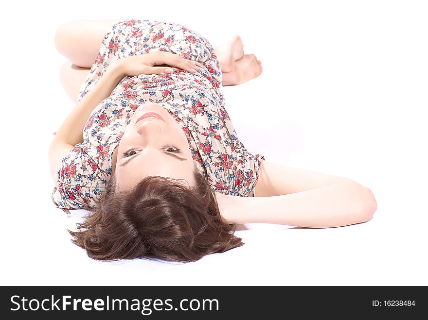 Young beautiful woman lying on the floor. White background. Studio shot. Young beautiful woman lying on the floor. White background. Studio shot.