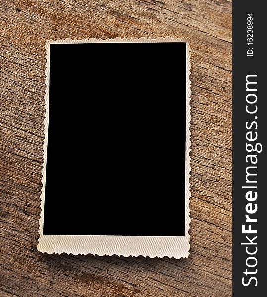 Vintage blank photo frame on wooden background