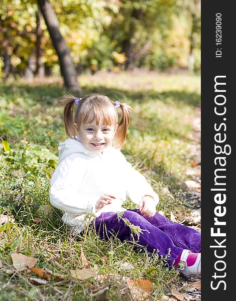 Little girl playing in autumn park. Little girl playing in autumn park