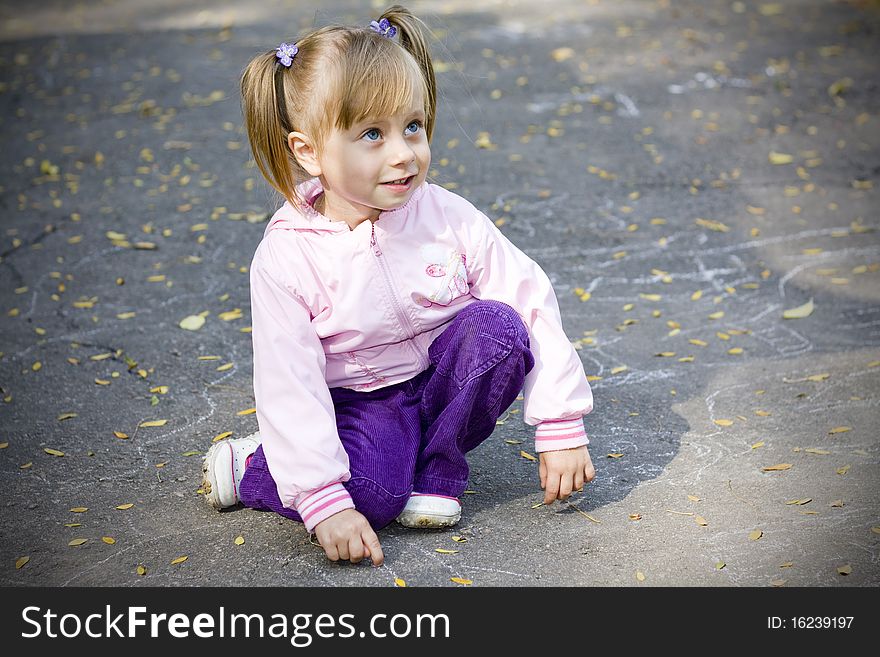 Little girl playing in autumn park. Little girl playing in autumn park