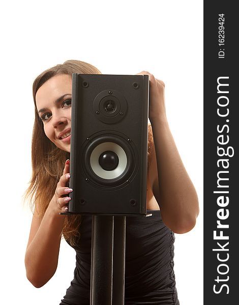 A young girl near a speaker on the white isolated background. A young girl near a speaker on the white isolated background