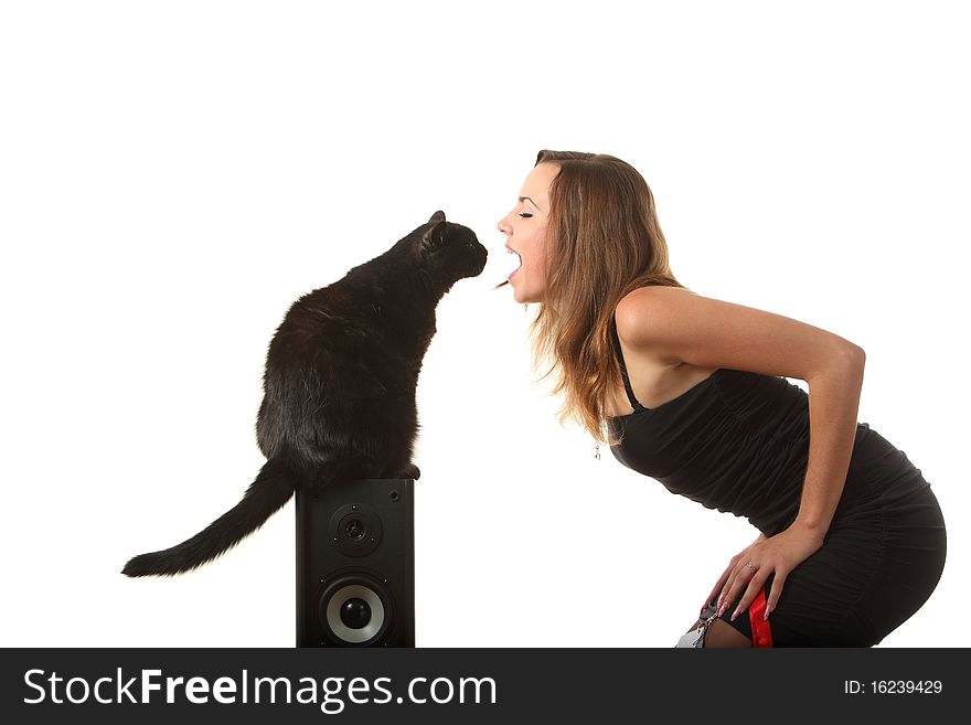 A black cat looks into the girls mouth. A black cat looks into the girls mouth