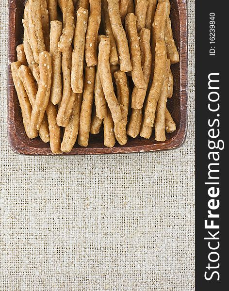 Wholegrain sticks with sesame seed in wooden bwol