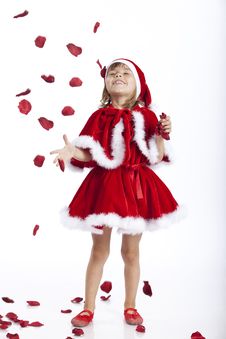 Happy Little Santa Girl And Flying Rose Petals Stock Photography Happy Little Santa Girl And Flying Rose Petals Stock Photography