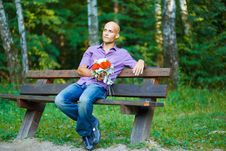 Guy With Bouquet Waiting For His Girlfriend Outsid Royalty Free Stock Photos
