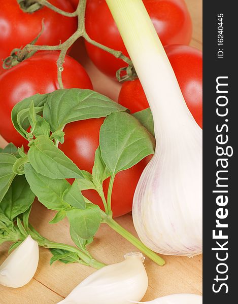 Typical ingredients of italian cuisine: basil, garlic and tomatoes. Studio shot. Shallow DOF