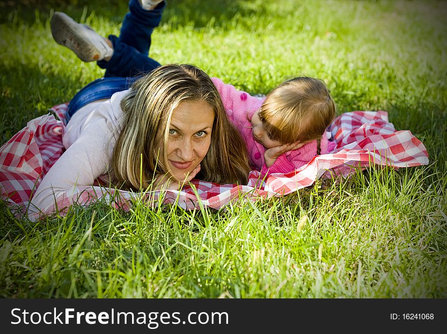 A little girl with her mother in the garden