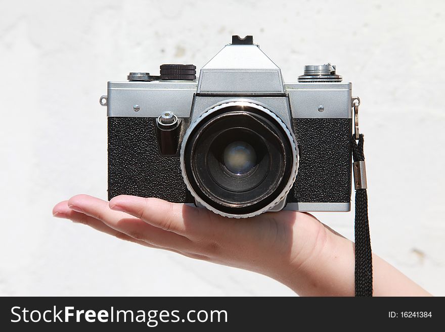 Old Praktica camera held in the palm of a hand