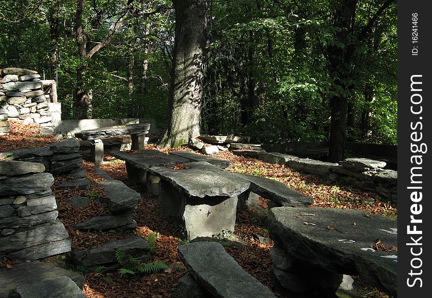 Stone seats and tables of the fregee a typical crotto in the mountains over Chiavenna (Italy)