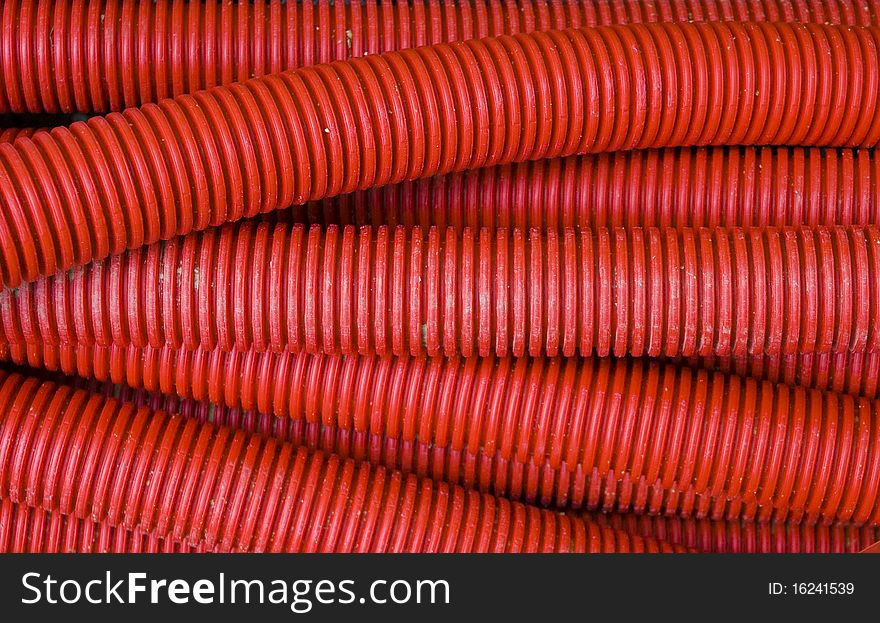 Thick corrugated tube and pipe red. Thick corrugated tube and pipe red