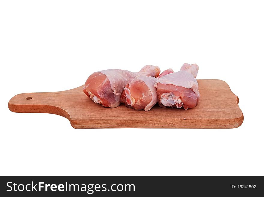 Chicken drumstick on the board on a white background