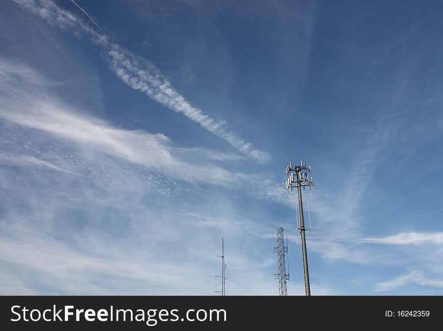 Cell phone tower against a blue sky with wispy clouds. Cell phone tower against a blue sky with wispy clouds.