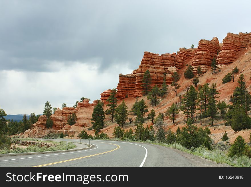 Road running through Bryce Canyon, Utah with rain clouds coming in