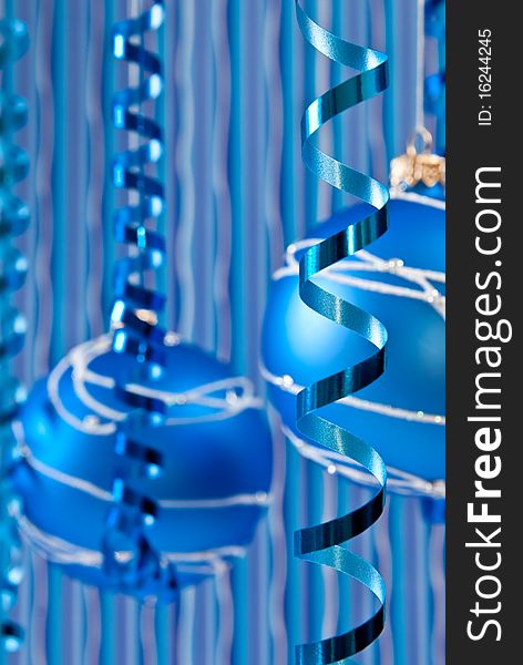 Christmas decoration from two blue balls and ribbons. Focus on ribbon. Christmas decoration from two blue balls and ribbons. Focus on ribbon