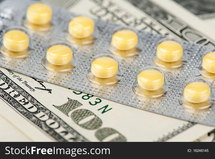 Pills and US dollars closeup