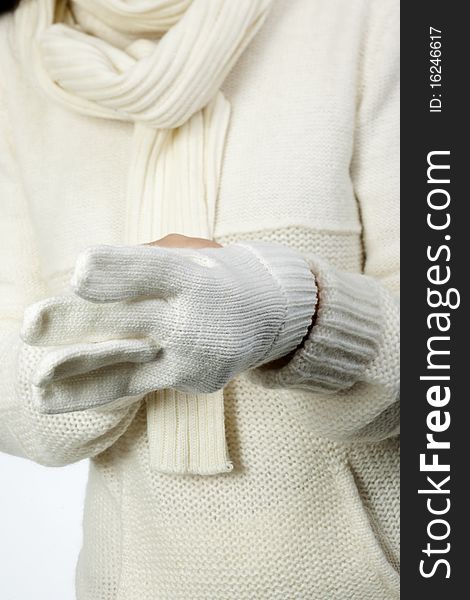 Young woman in soft white sweater, wearing mittens. Young woman in soft white sweater, wearing mittens