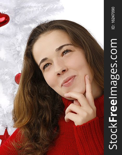 Beautiful young woman next to christmas tree