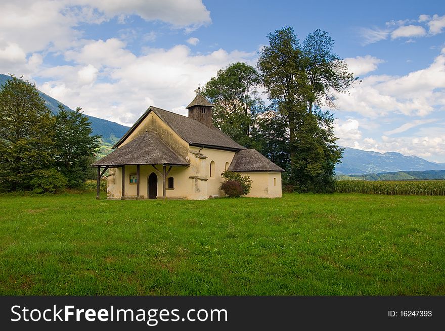 Countryside's church. mountains landscape on background