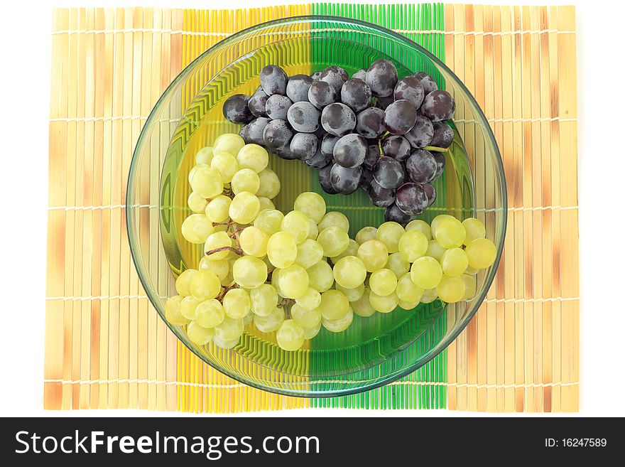 Green and black grapes on a plate