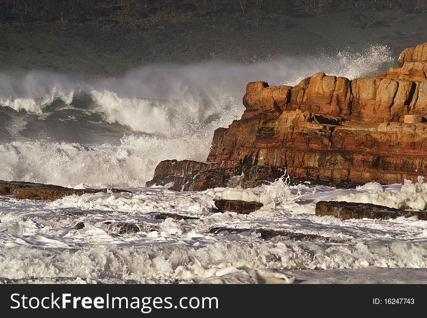 Waves break over rocks at South Arm near Hobart, Tasmania. Waves break over rocks at South Arm near Hobart, Tasmania