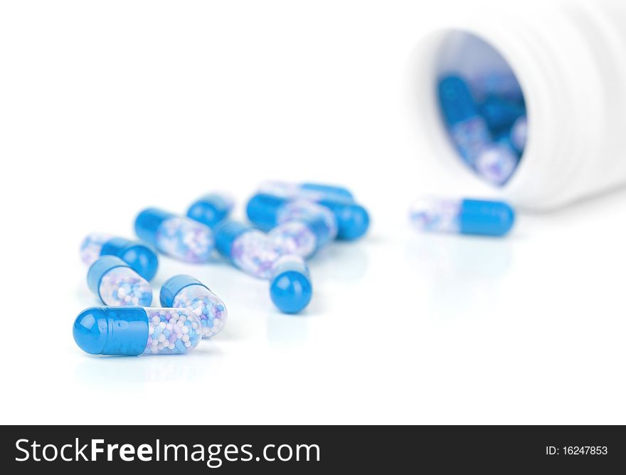 Closeup blue pills isolated on a white background