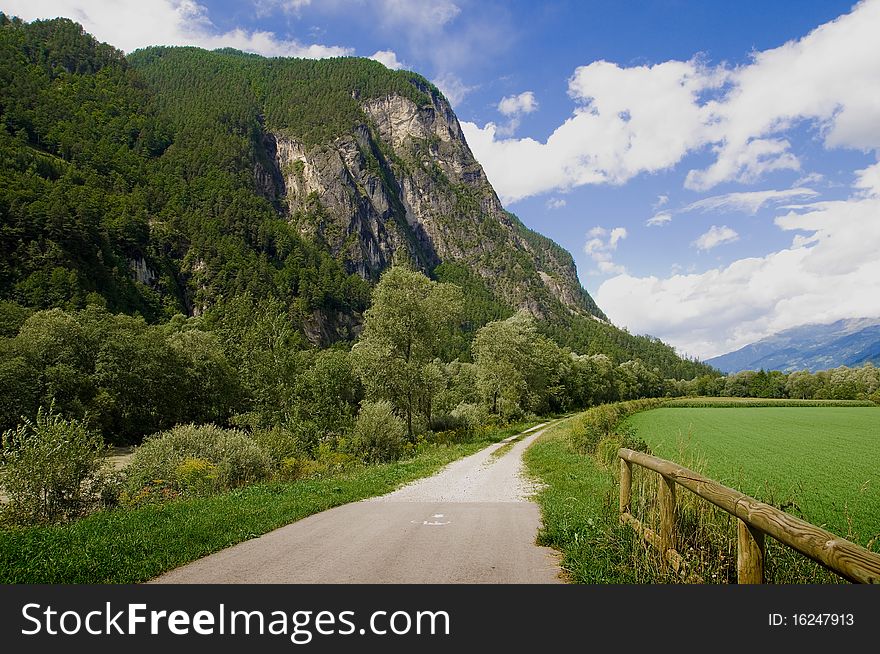 Drava road cycling landscape. Mountains, sky and clouds on background