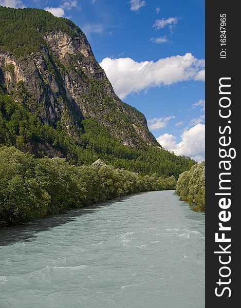 Drava river landscape. Mountains, sky and clouds on background