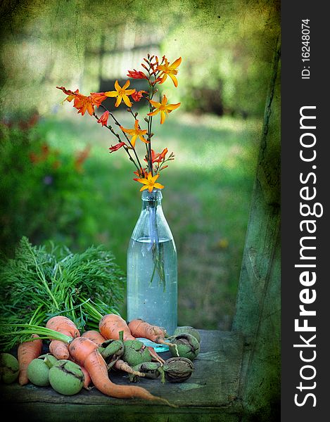 still life with flowers by a carrot and walnuts. still life with flowers by a carrot and walnuts