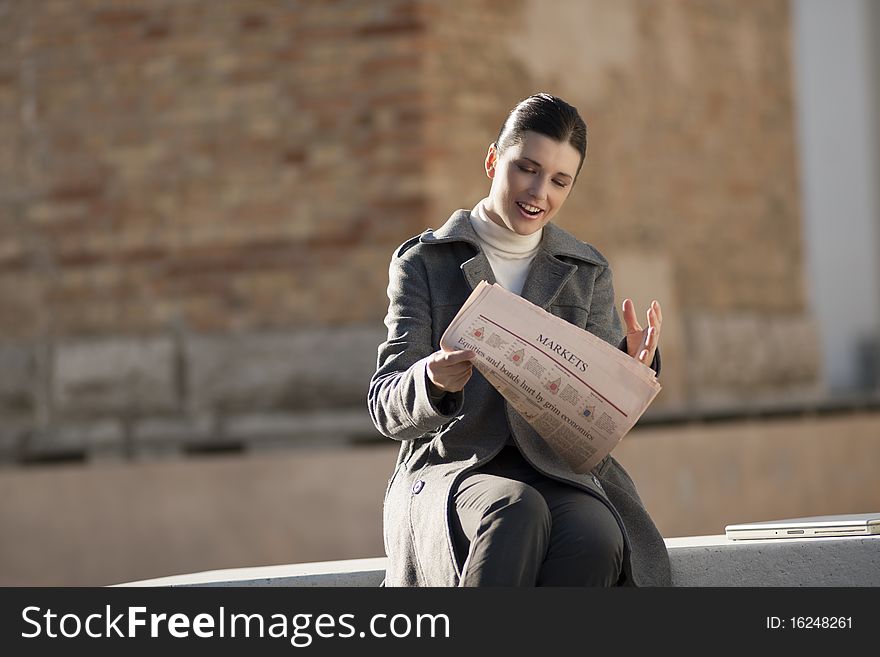 Young Woman Taking A Rest With Newspaper