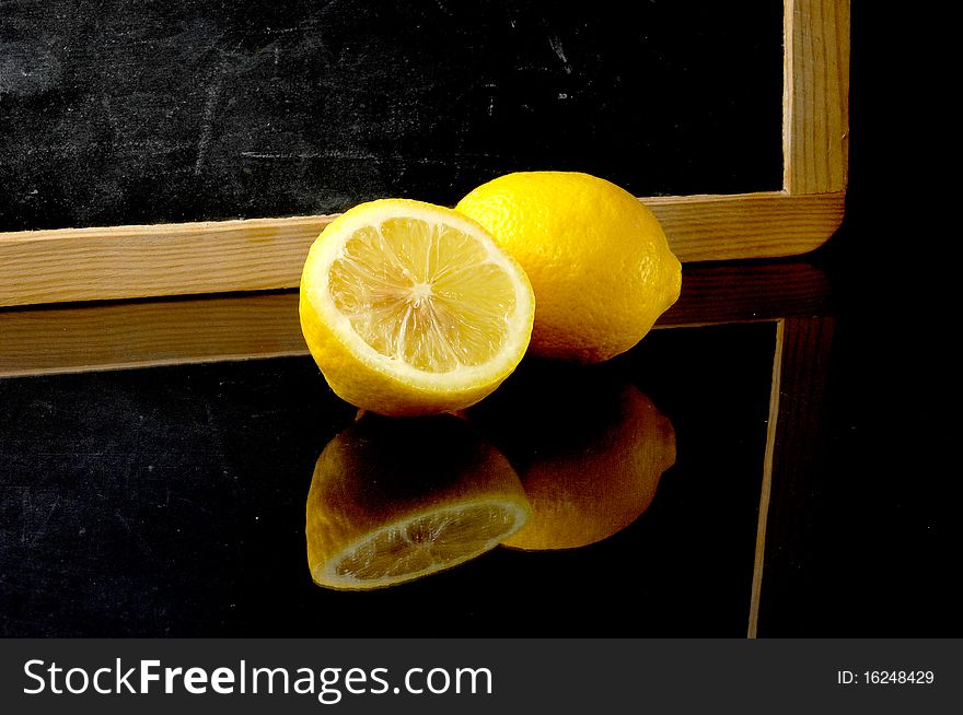 Half lemon and blackboard on background