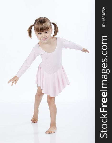 Full lenght portrait of a little ballerina dancing and smiling. Full lenght portrait of a little ballerina dancing and smiling