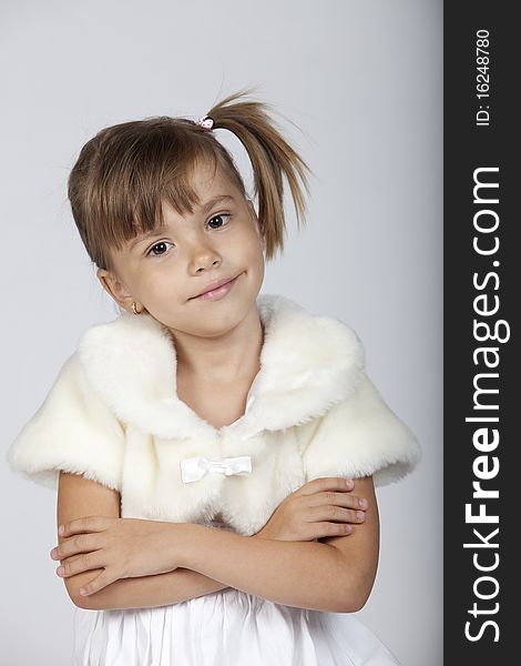 Portrait of a fashionable little girl, studio image. Portrait of a fashionable little girl, studio image