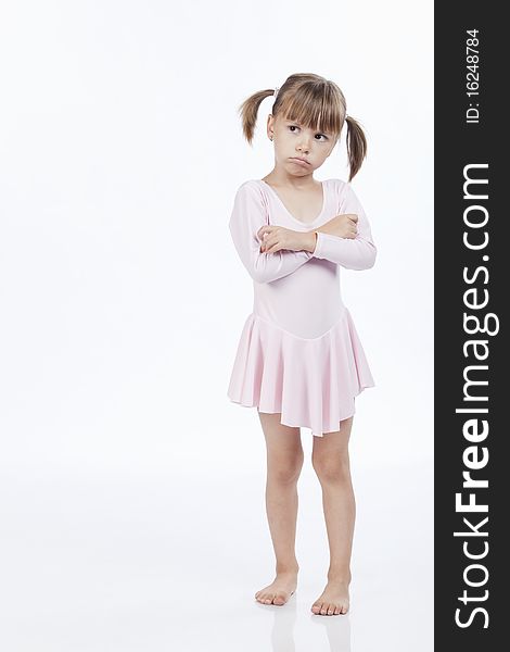 Upset little girl in pink outfit