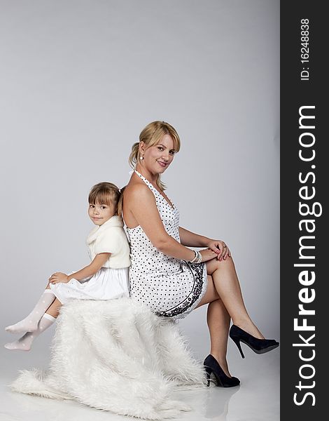 Portrait of two, young mother and cute daughter, posing. Studio image. Portrait of two, young mother and cute daughter, posing. Studio image