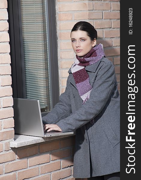 Businesswoman working with laptop outdoors. Businesswoman working with laptop outdoors