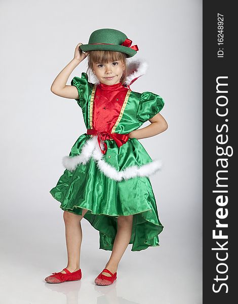 Full length portrait of an adorable little girl wearing green outfit and hat for Saint Patrick's Day, studio image. Full length portrait of an adorable little girl wearing green outfit and hat for Saint Patrick's Day, studio image