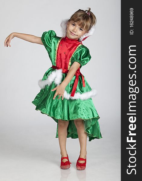 Full length portrait of a cheerful little girl wearing green dress on Saint Patrick's Day, studio image. Full length portrait of a cheerful little girl wearing green dress on Saint Patrick's Day, studio image