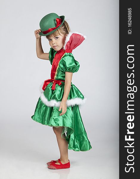 Full length portrait of an adorable little girl wearing green outfit and hat for Saint Patrick's Day, studio image. Full length portrait of an adorable little girl wearing green outfit and hat for Saint Patrick's Day, studio image