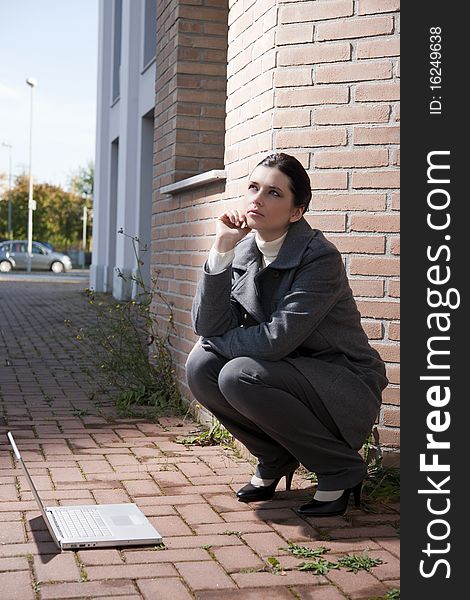 Young business woman with notebook, outdoors