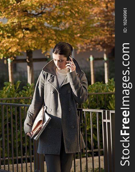 Young woman on the mobile phone, outdoors