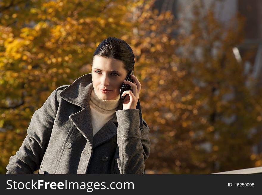 Young woman on the mobile phone, outdoors