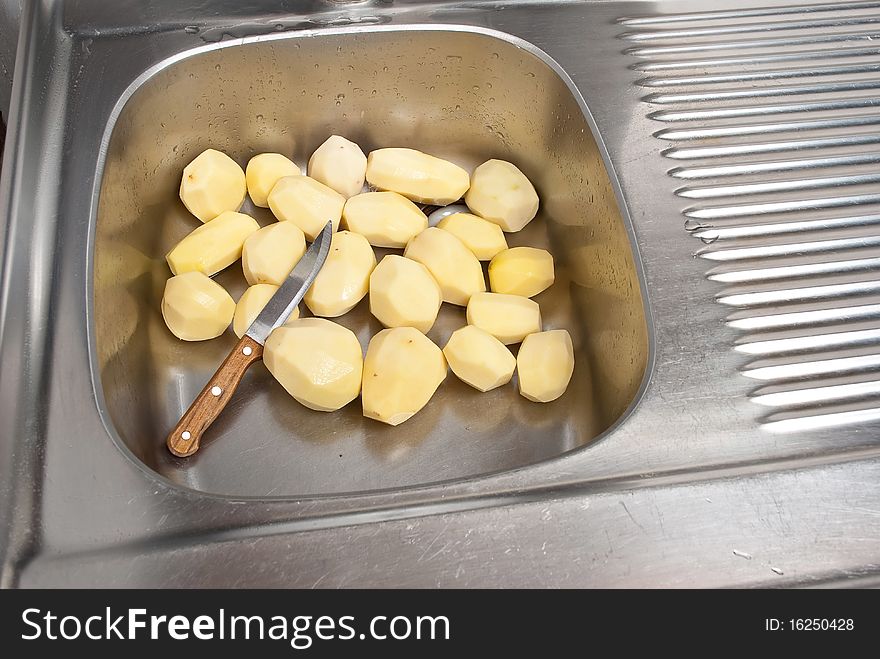 Peeling potatoes with old knife. Peeling potatoes with old knife