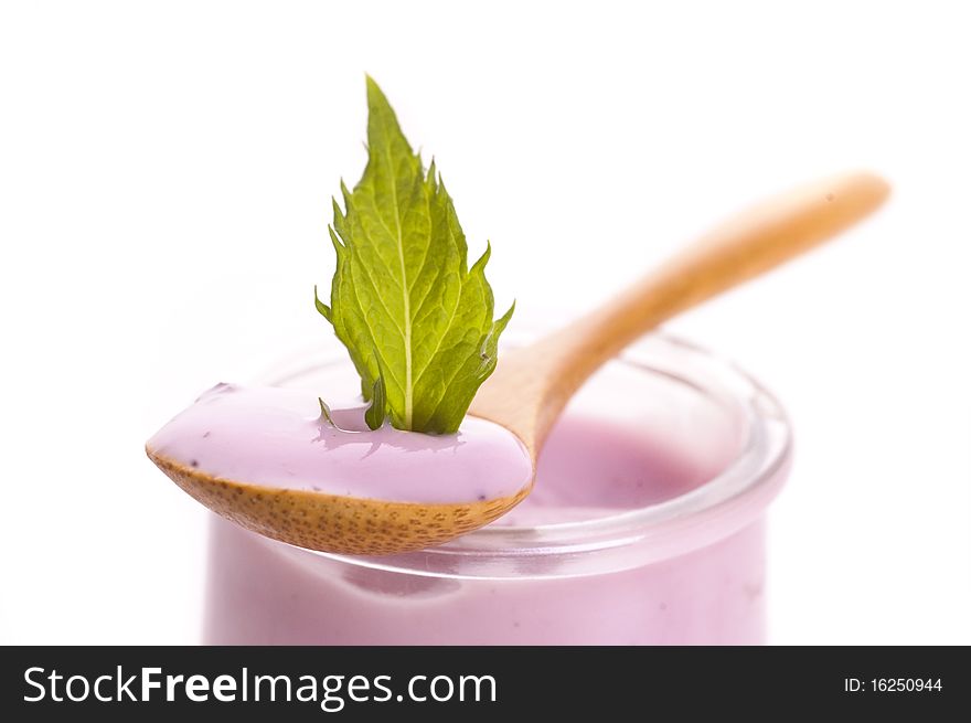 Bowl of blueberry yoghurt on white background