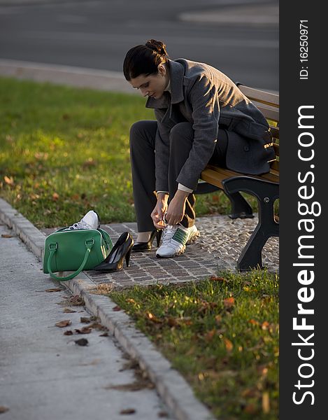 Young business woman changing shoes