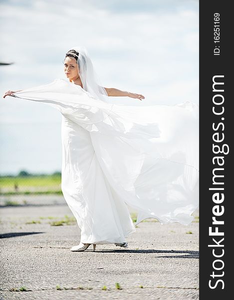 Beauty bride dance on  airfield