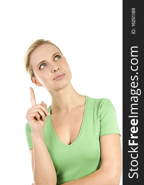 Young woman pointing at copy space; she is green dressed, maybe pointing at something concerned with nature and environment