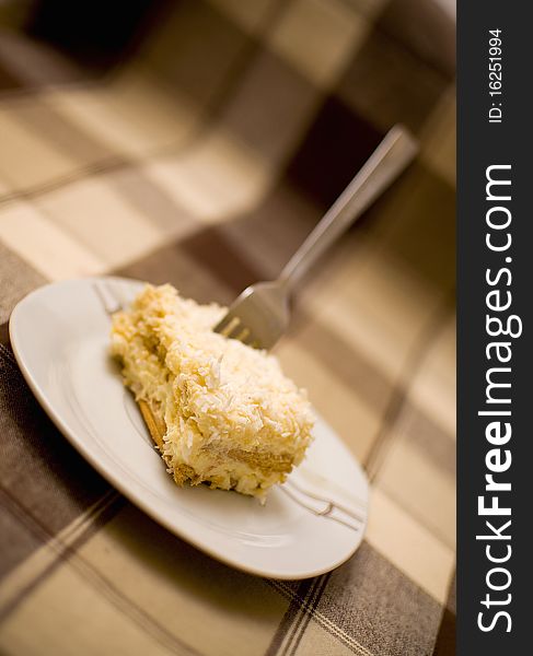 Pice of cake with fork in it, blurred background. Pice of cake with fork in it, blurred background