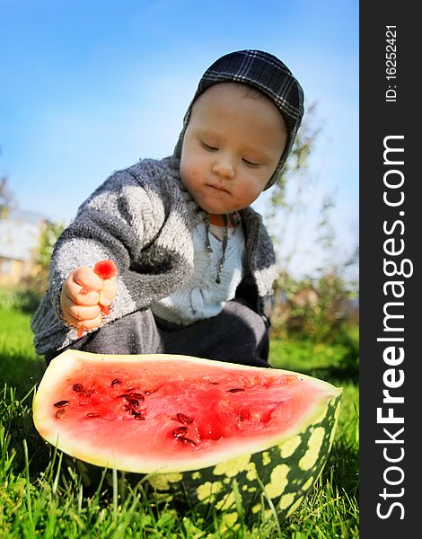 The boy presses a water-melon hands