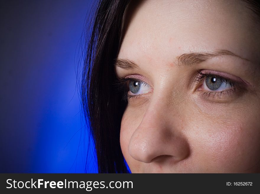 Portrait of a Girl close-up on blue background